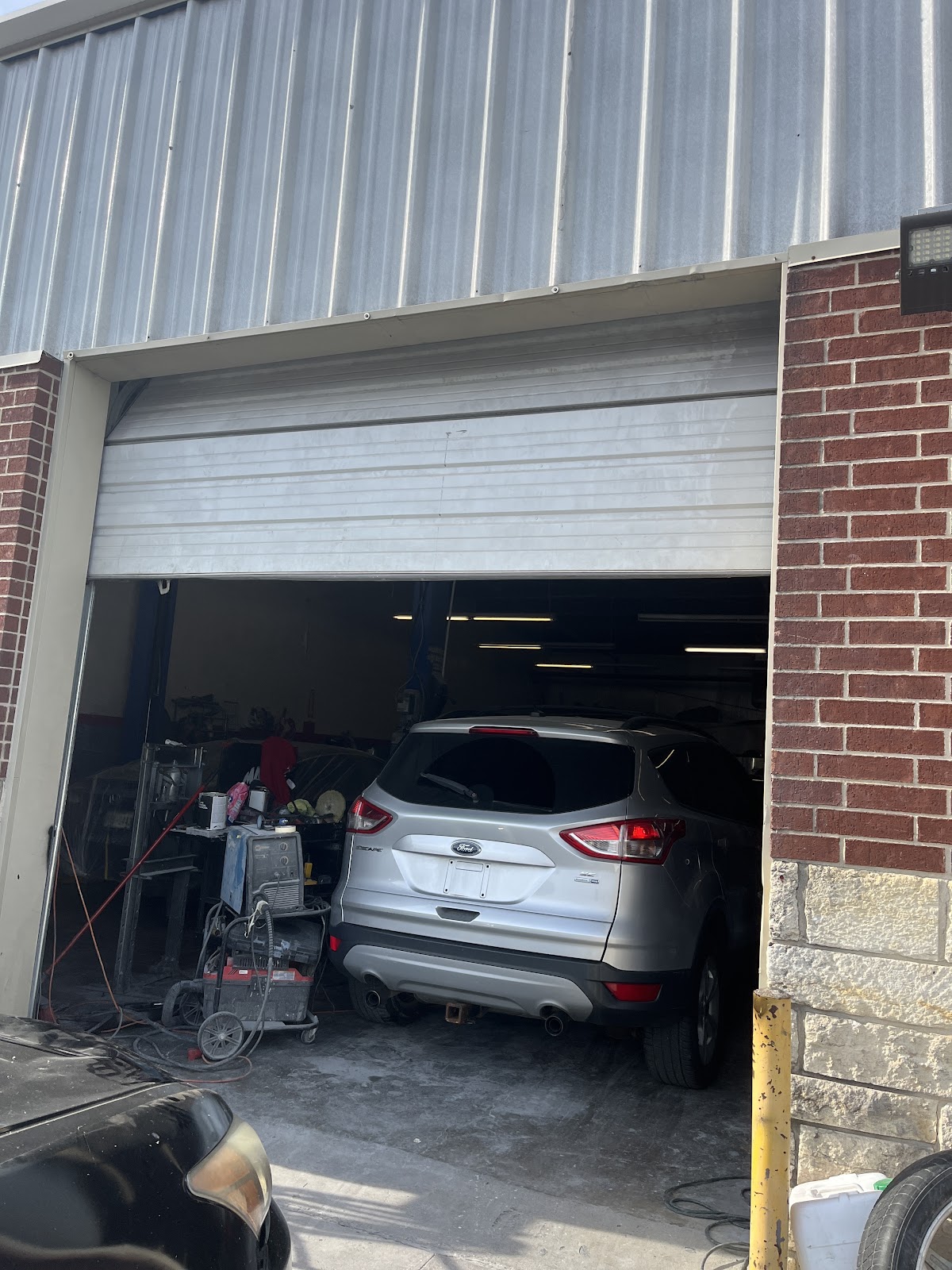 Repair bay at 8SRT Collision and Paint with an SUV in for collision work